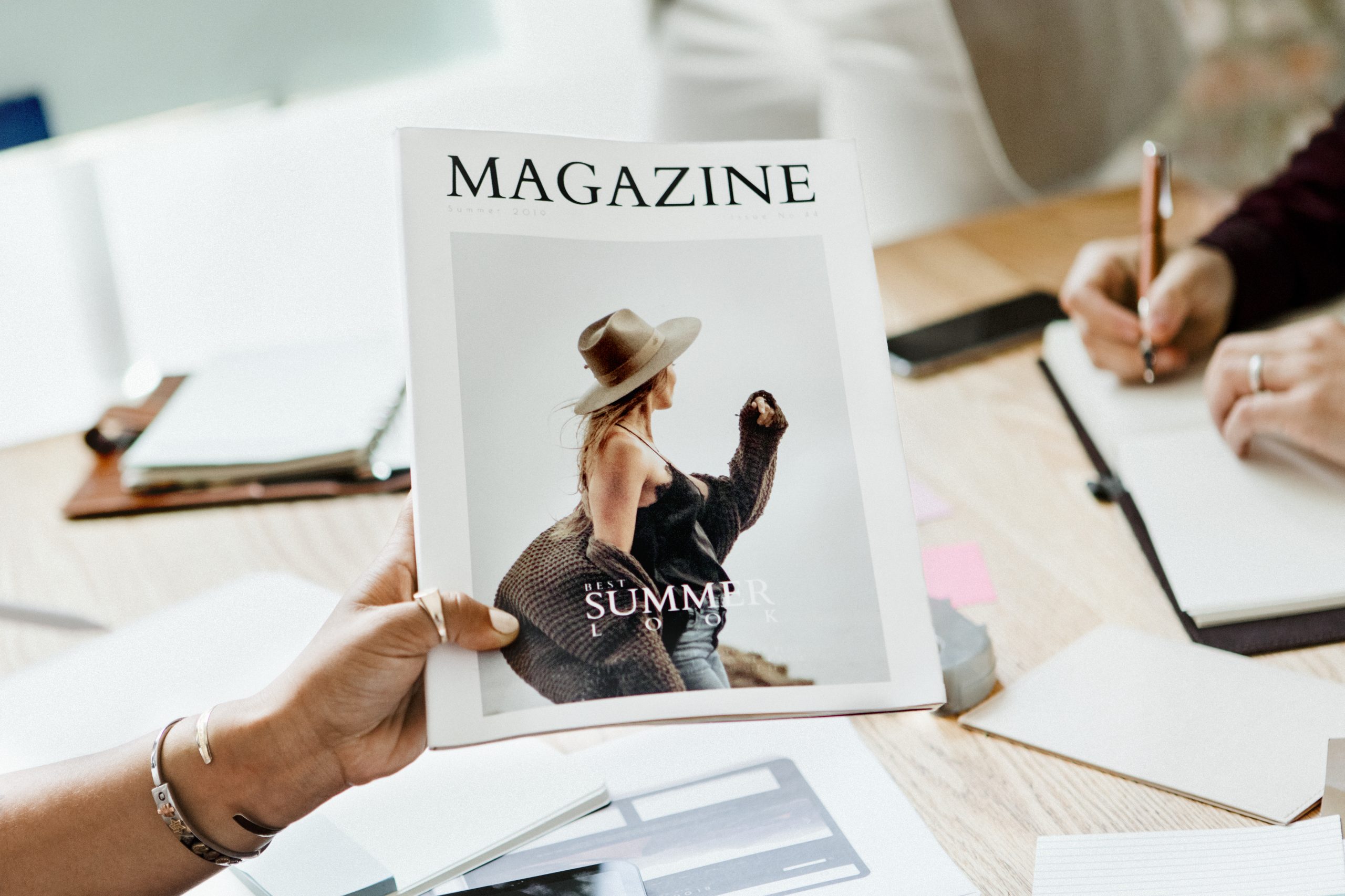 Creative people working on magazine cover design Creative people working on magazine cover design